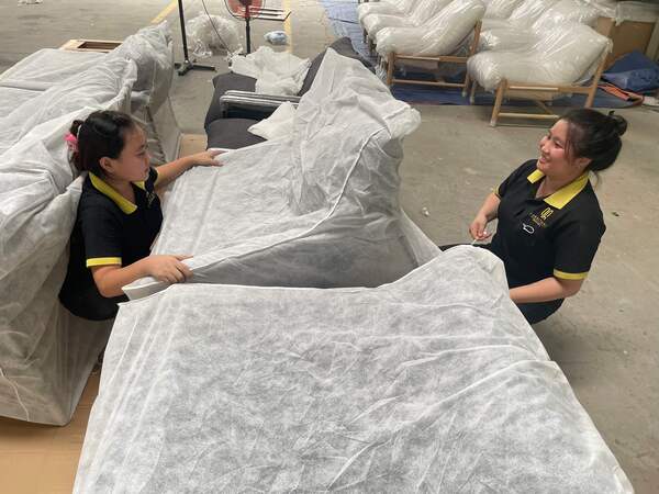 QA Furniture's sofa products are packaged after completing the production process
