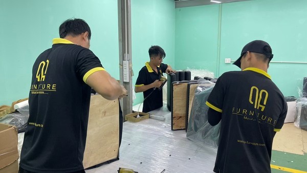 Workers producing sofas at QA Furniture