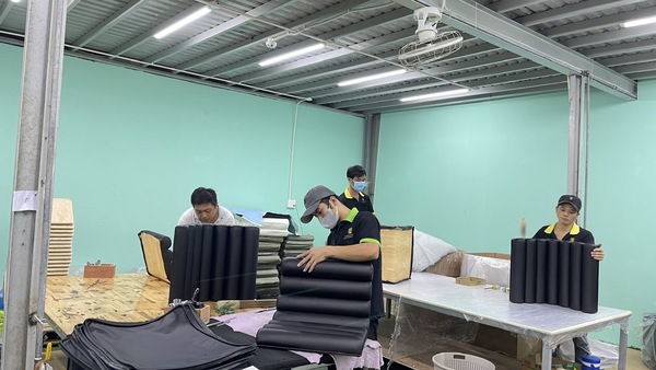 The QA Furniture team works diligently at the factory