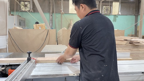 Technical staff measure and cut wood according to design