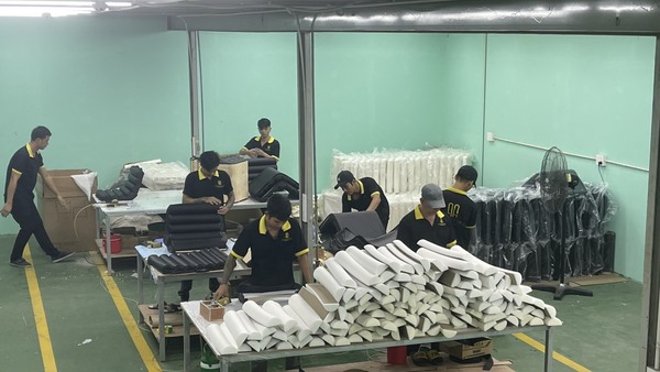 The QA Furniture upholstered team is working diligently at the factory