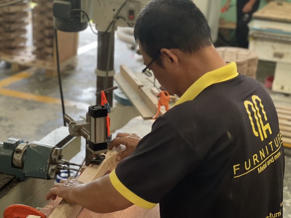 QA Furniture staff is grinding wood to create a frame