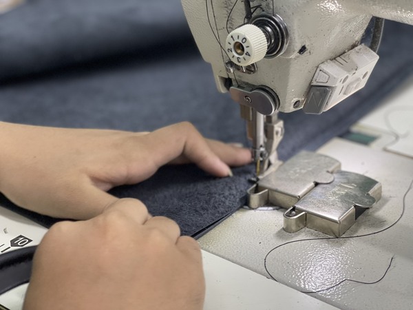 Employees are sewing and upholstering furniture