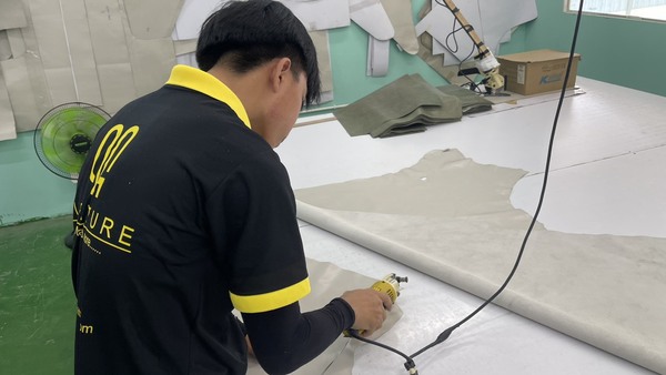 QA Furniture technicians are meticulous in using fabric-cutting for upholstery.