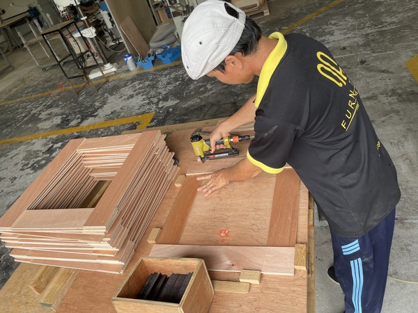 QA Furniture staff are cutting and assembling chair frames