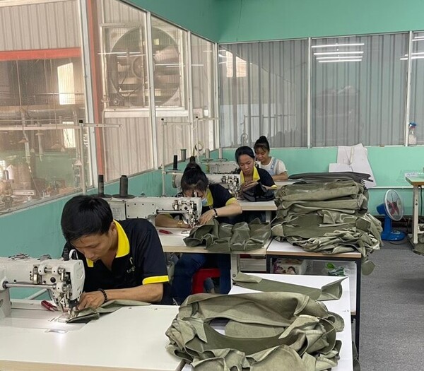 QA Furniture Workers Upholstering a Sofa