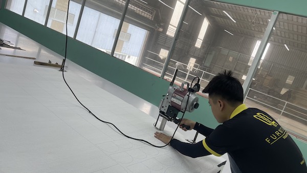 Staff cutting fabric to cover sofa cushions