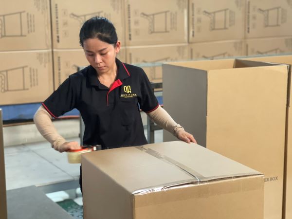 QA Furniture staff are packaging products for customers