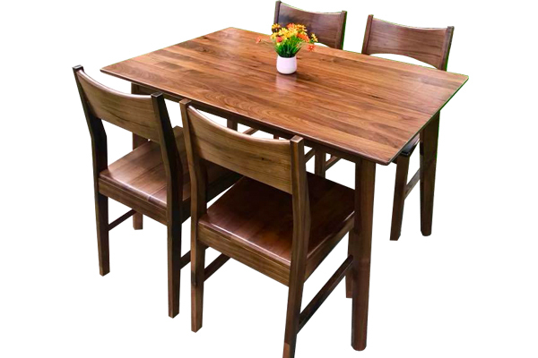 The dining table is made from walnut wood