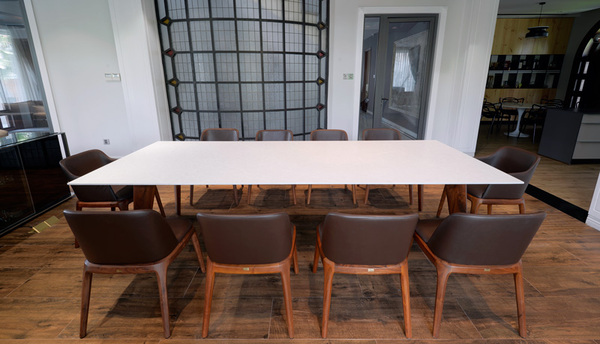 The dining table is made of teak wood