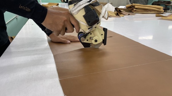 Workers prepare upholstery materials